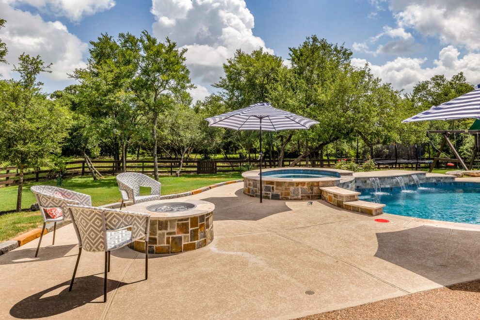 Pool - mid-sized backyard custom-shaped natural pool idea with decking