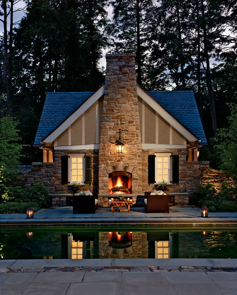 Large elegant backyard concrete paver patio photo in New York