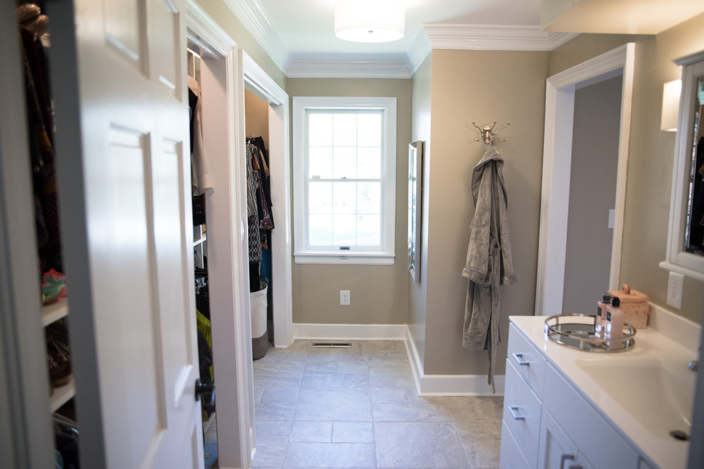 Photo of a mid-sized transitional 3/4 bathroom in Indianapolis with shaker cabinets, white cabinets, an alcove shower, mosaic tile, beige walls, travertine floors, an integrated sink, solid surface benchtops, a drop-in tub, beige floor and a hinged shower door.