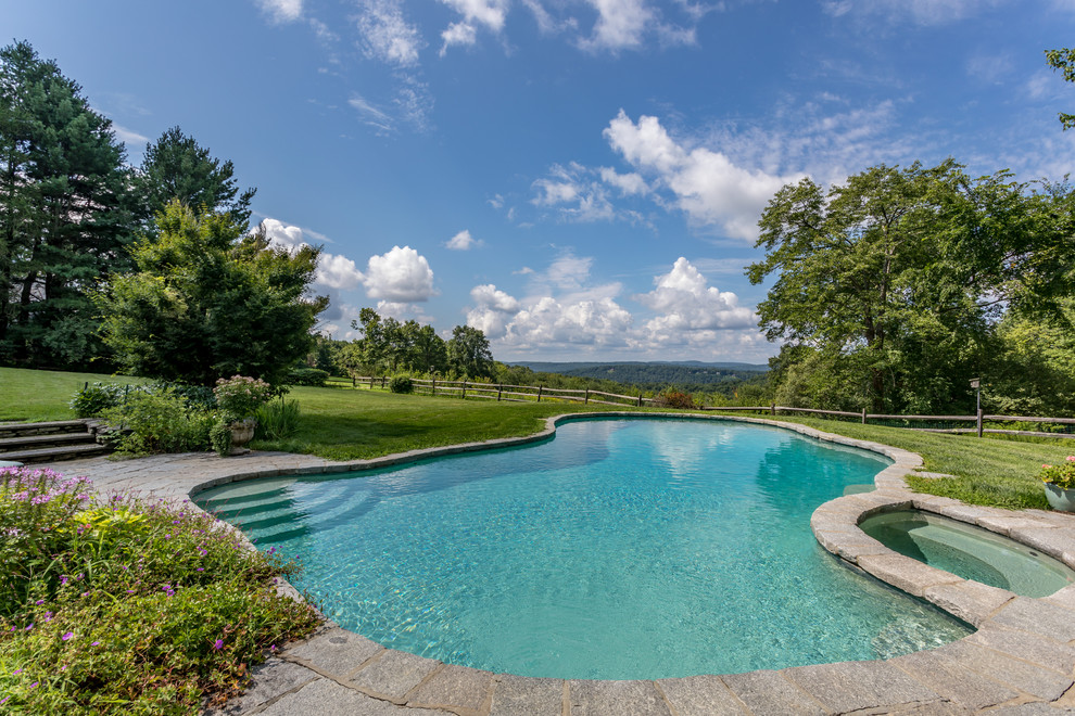 Inspiration for a country backyard custom-shaped lap pool in New York with a hot tub.
