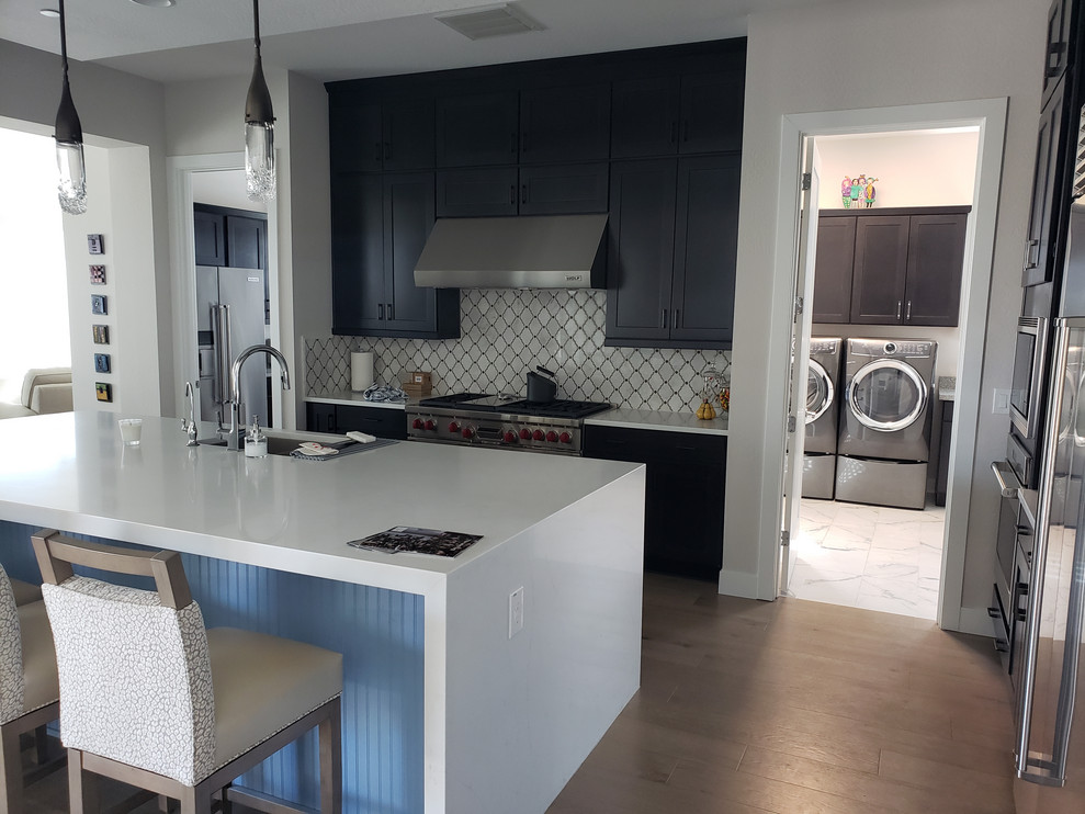 Inspiration for a huge transitional porcelain tile eat-in kitchen remodel in Phoenix with an undermount sink, shaker cabinets, dark wood cabinets, quartz countertops, multicolored backsplash, mosaic tile backsplash, stainless steel appliances, an island and white countertops
