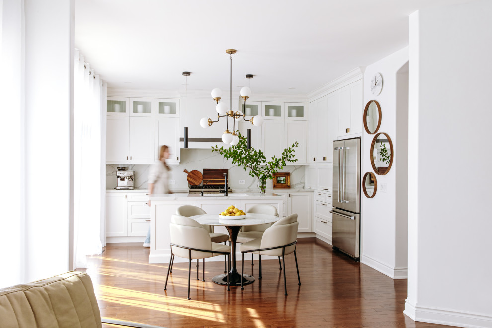 Eat-in kitchen - mid-sized transitional l-shaped dark wood floor and brown floor eat-in kitchen idea in Toronto with an undermount sink, shaker cabinets, white cabinets, quartz countertops, white backsplash, quartz backsplash, black appliances, an island and white countertops