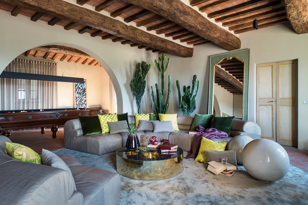 Inspiration for an expansive mediterranean open concept family room in Florence with beige walls and brick floors.