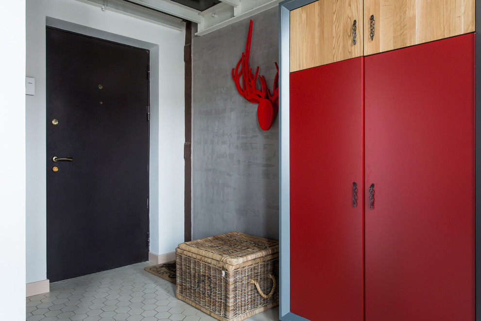 Industrial entryway in Moscow with grey walls, a single front door and a black front door.