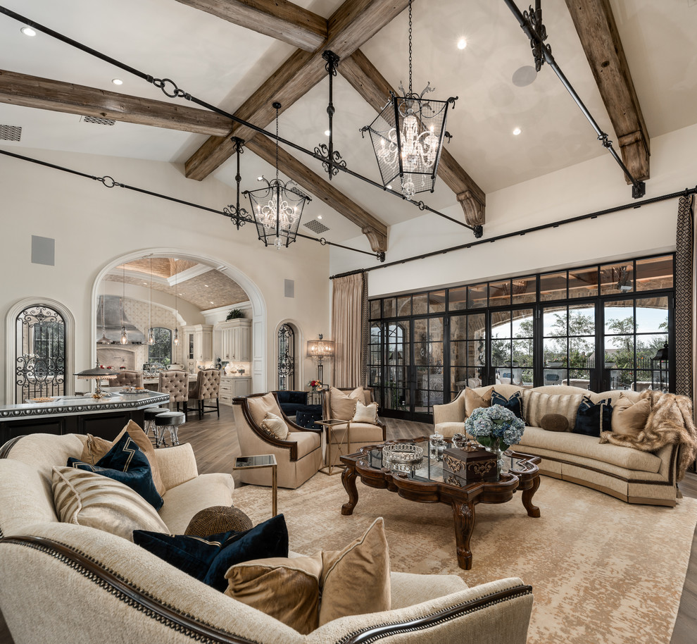 Inspiration for an expansive modern open concept living room in Phoenix with a home bar, white walls, dark hardwood floors, a standard fireplace, a stone fireplace surround, a wall-mounted tv and brown floor.