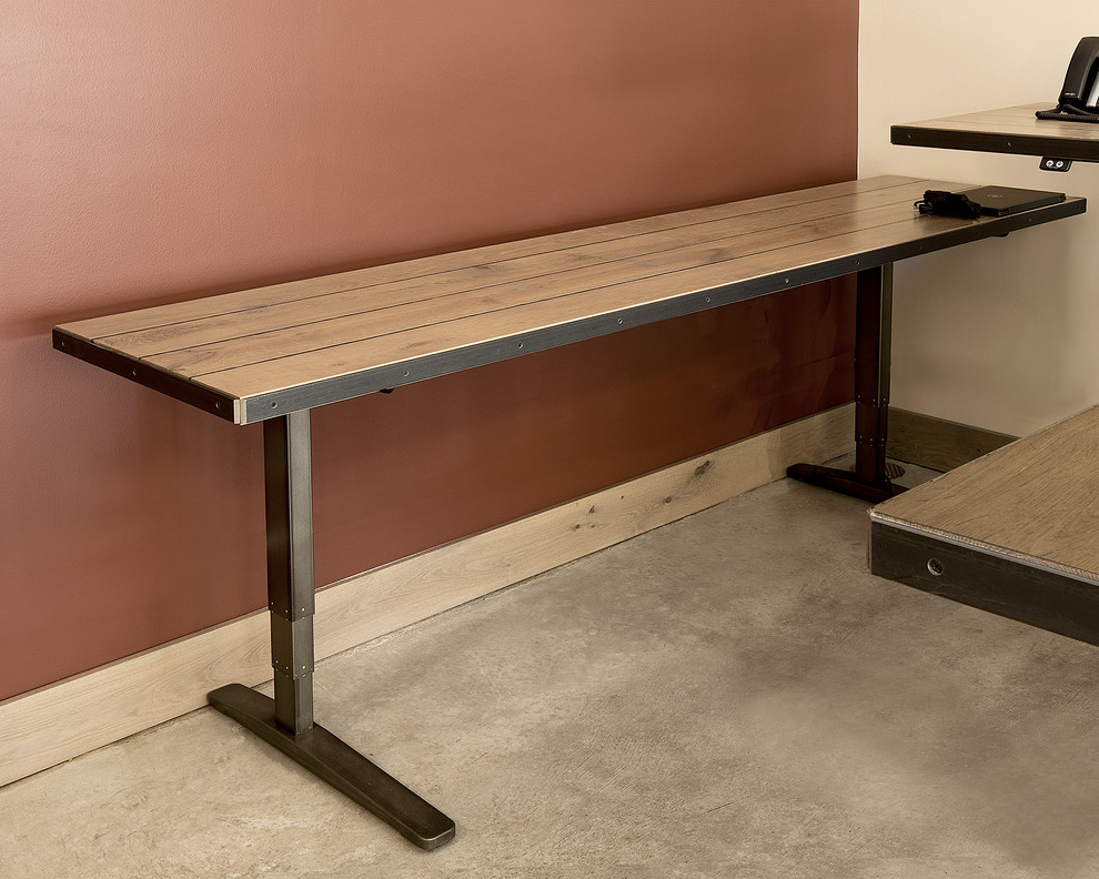 Inspiration for a large industrial study room in Denver with concrete floors and a freestanding desk.
