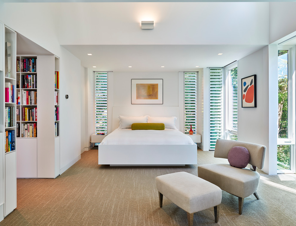This is an example of a contemporary master bedroom in DC Metro with white walls and carpet.