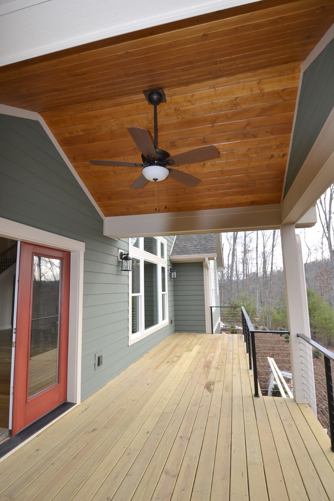 Inspiration for a mid-sized traditional deck in Other with a roof extension.
