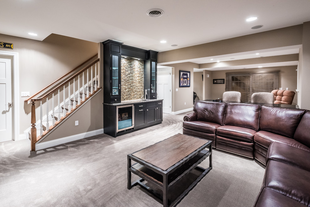 Basement - large transitional walk-out carpeted basement idea with beige walls and no fireplace