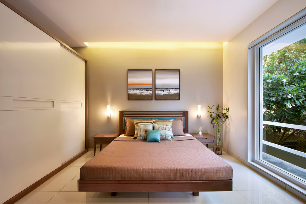 This is an example of a mid-sized contemporary bedroom in Ahmedabad with ceramic floors, beige floor and beige walls.