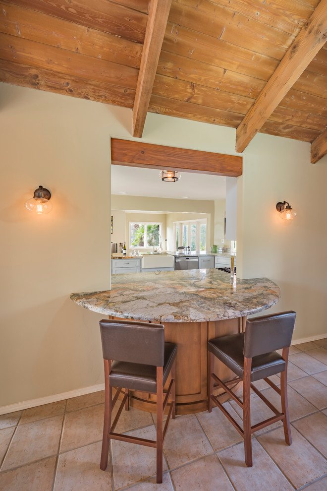 Photo of a large transitional kitchen/dining combo in San Diego with terra-cotta floors.