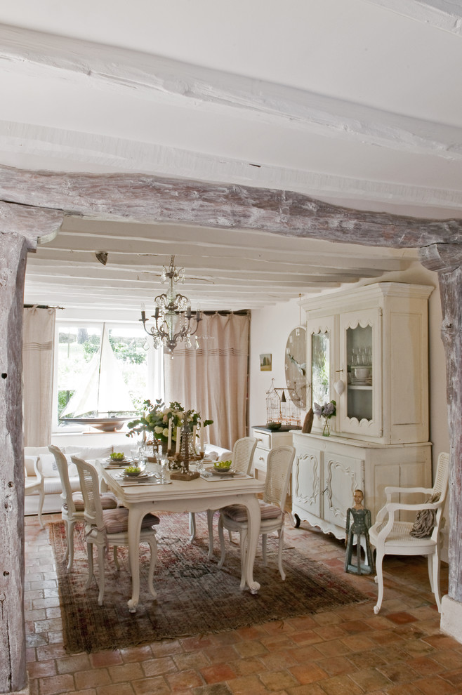 Photo of a dining room in Paris with white walls and no fireplace.