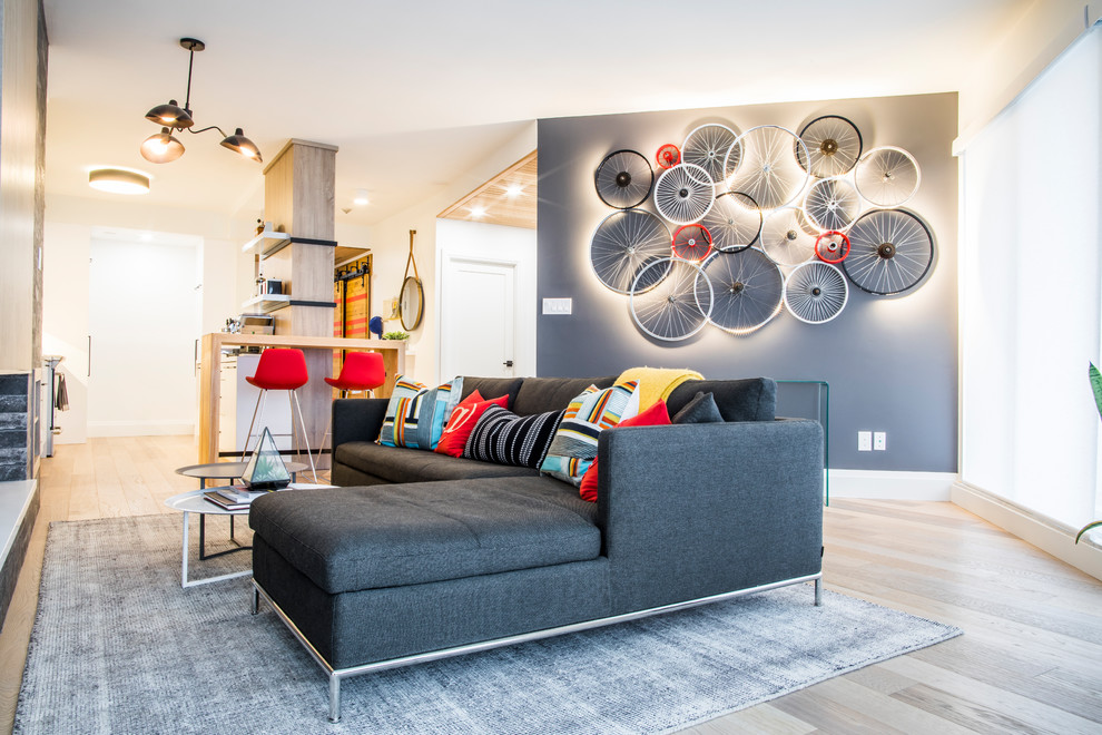 Contemporary open concept living room in Toronto with grey walls, light hardwood floors and beige floor.