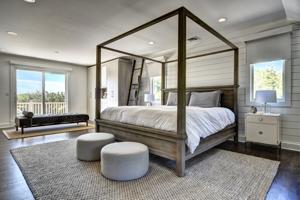 Design ideas for an expansive transitional master bedroom in New York with grey walls, medium hardwood floors, brown floor and planked wall panelling.