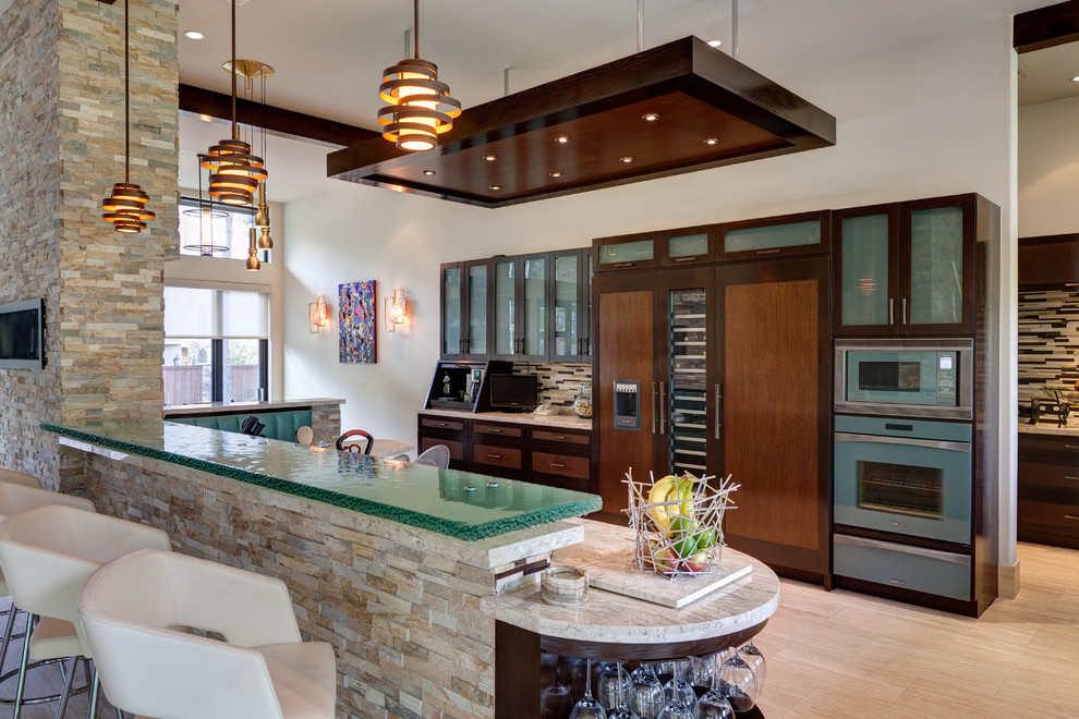 Photo of a contemporary kitchen in Houston with stainless steel appliances, glass benchtops and turquoise benchtop.