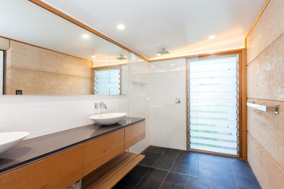 Photo of a mid-sized modern master bathroom in Central Coast with light wood cabinets, an open shower, white tile, stone tile, white walls, slate floors, a vessel sink, engineered quartz benchtops, black floor, an open shower, black benchtops and flat-panel cabinets.