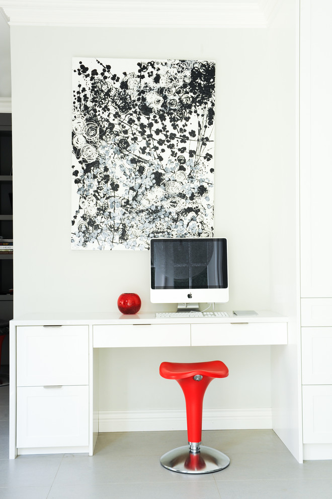 Photo of a transitional home office in Vancouver with white walls and a built-in desk.