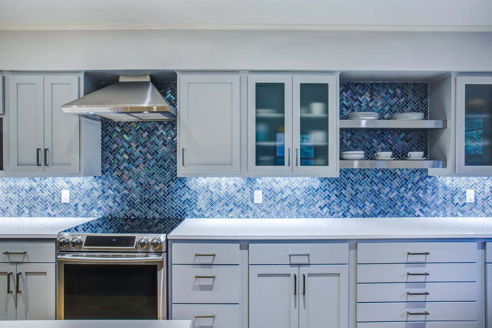 Inspiration for a large modern l-shaped eat-in kitchen in Dallas with an undermount sink, shaker cabinets, blue cabinets, quartz benchtops, blue splashback, mosaic tile splashback, stainless steel appliances, cork floors, with island, brown floor and white benchtop.