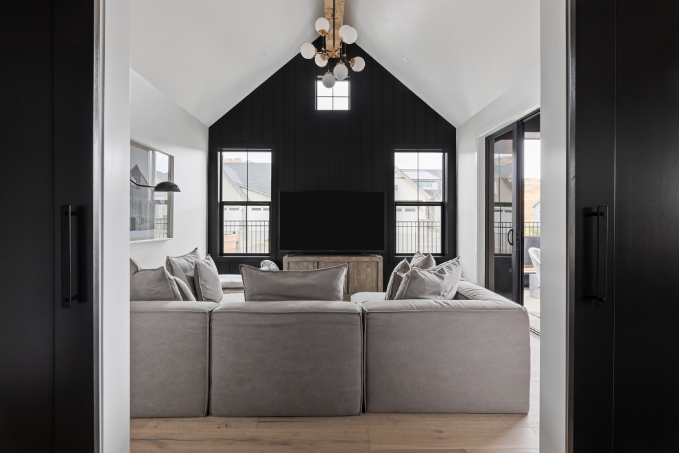 Foto de sala de estar cerrada y abovedada nórdica de tamaño medio sin chimenea con paredes blancas, suelo de madera clara, televisor independiente y suelo beige