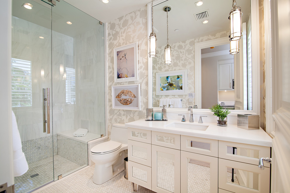 Expansive transitional bathroom in Miami with white cabinets, an alcove shower, a one-piece toilet, white tile, white walls, marble floors, an undermount sink, a hinged shower door and recessed-panel cabinets.