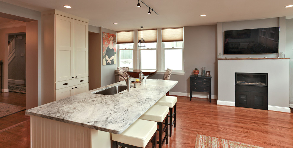 Photo of a contemporary eat-in kitchen in DC Metro with an undermount sink, shaker cabinets, white cabinets, granite benchtops and stainless steel appliances.