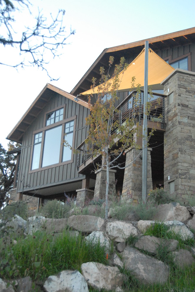 This is an example of a mid-sized transitional three-storey brown house exterior in Denver with concrete fiberboard siding, a shed roof and a metal roof.