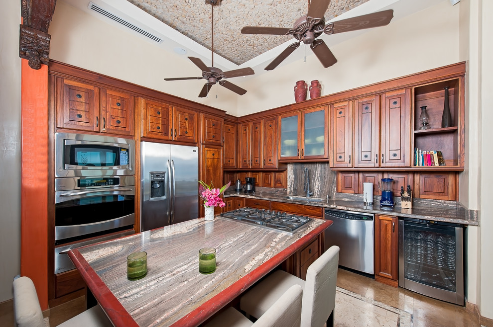 Photo of a mediterranean l-shaped kitchen in Other with medium wood cabinets and stainless steel appliances.