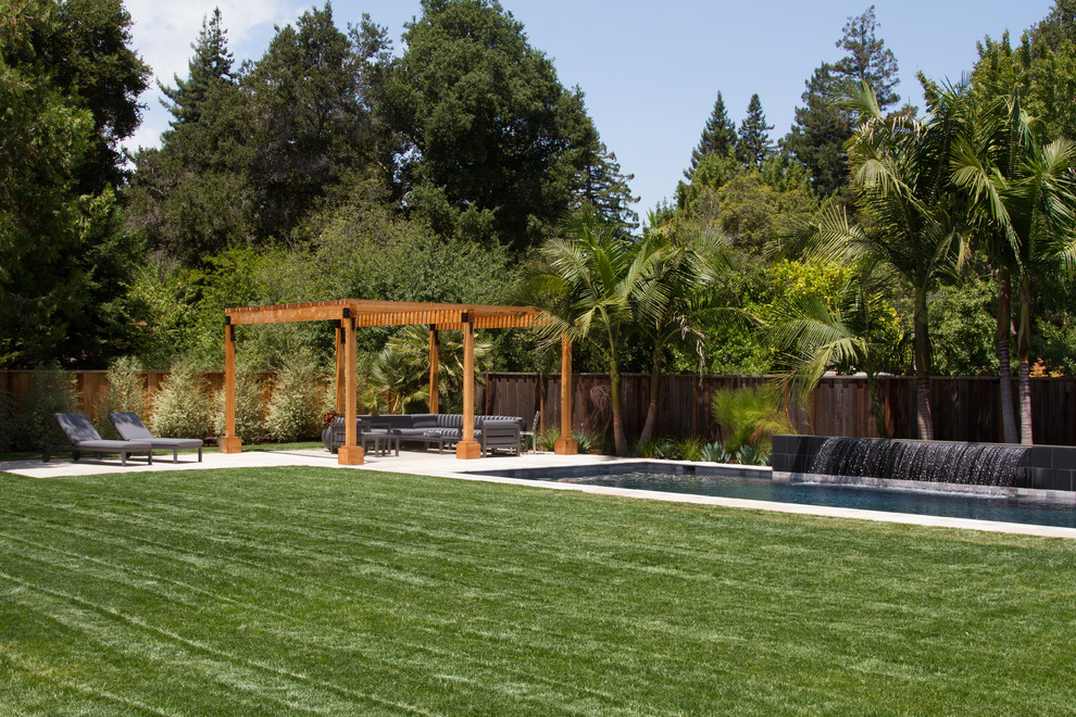 Photo of a large contemporary full sun backyard wood fence landscaping in San Francisco with a pergola.