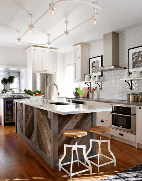 Example of a mid-sized mountain style single-wall porcelain tile eat-in kitchen design with a farmhouse sink, subway tile backsplash, stainless steel appliances and two islands