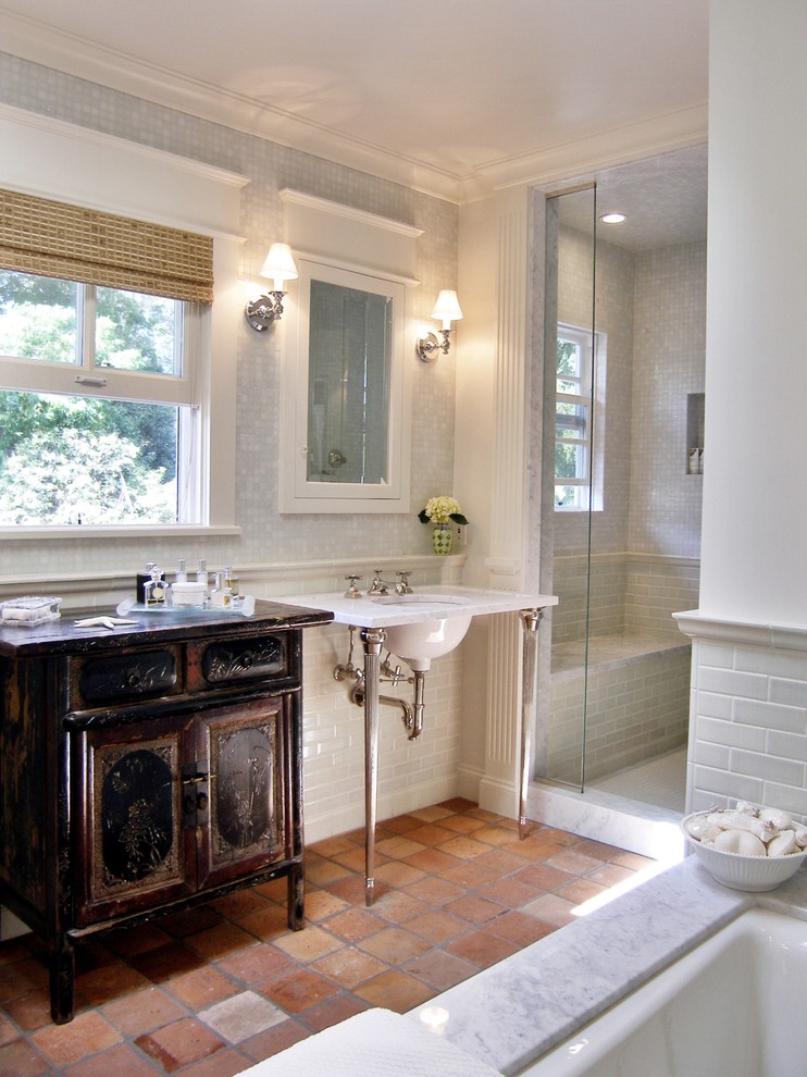 Design ideas for a mid-sized traditional master bathroom in Los Angeles with a pedestal sink, distressed cabinets, marble benchtops, an undermount tub, an alcove shower, a two-piece toilet, green tile, mosaic tile, white walls and terra-cotta floors.