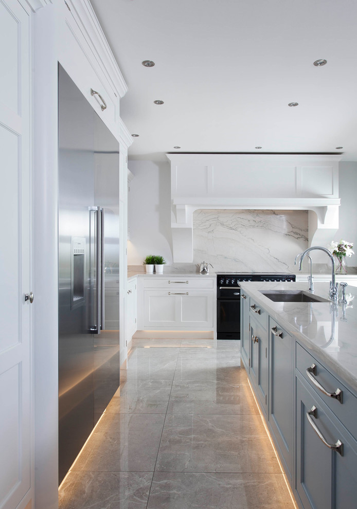 Photo of a mid-sized transitional l-shaped open plan kitchen in Other with an integrated sink, shaker cabinets, blue cabinets, marble benchtops, grey splashback, marble splashback, stainless steel appliances, porcelain floors, with island and grey floor.