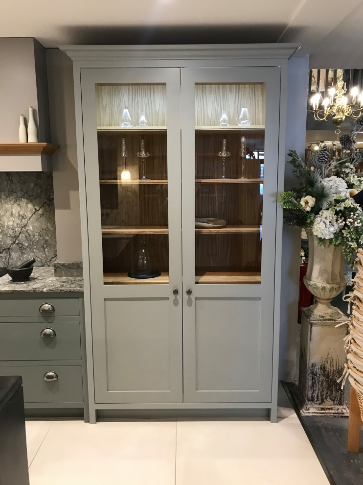 This is an example of a contemporary kitchen in West Midlands with shaker cabinets, grey cabinets and an island.