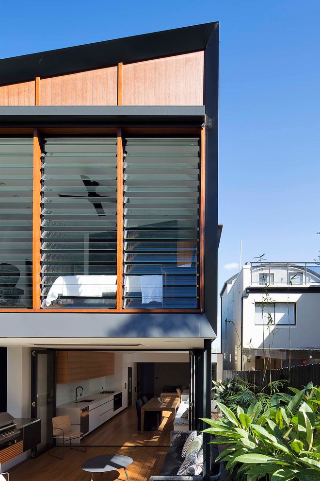 Design ideas for a modern two-storey house exterior in Sydney with wood siding.