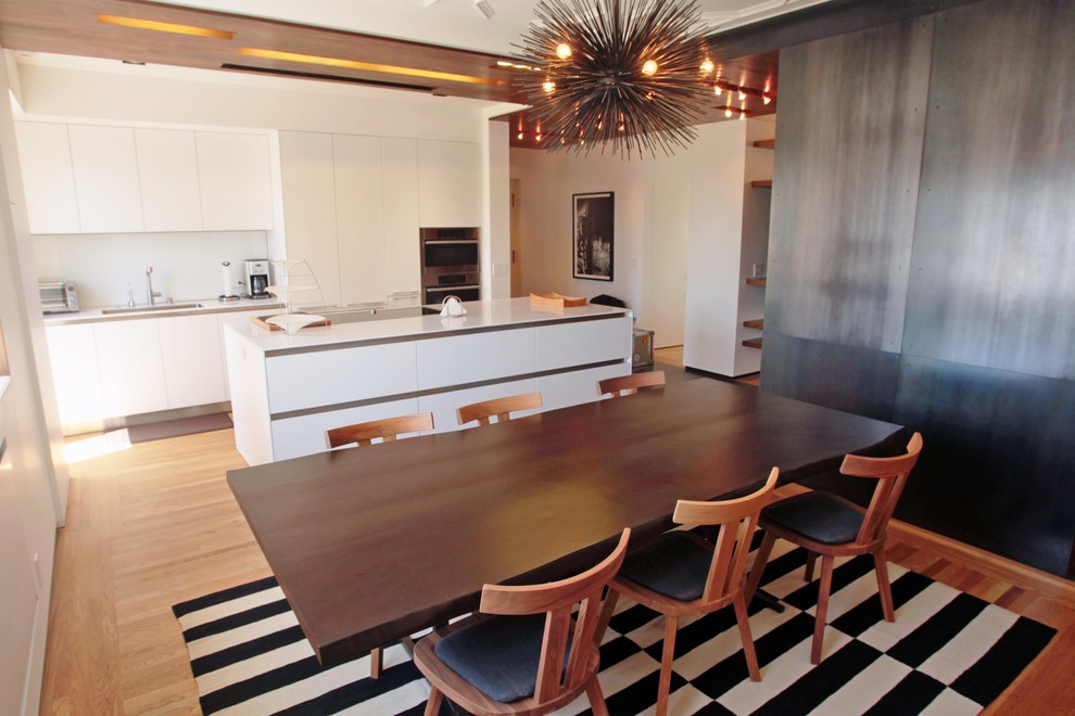Inspiration for a contemporary eat-in kitchen in San Francisco with flat-panel cabinets and white cabinets.