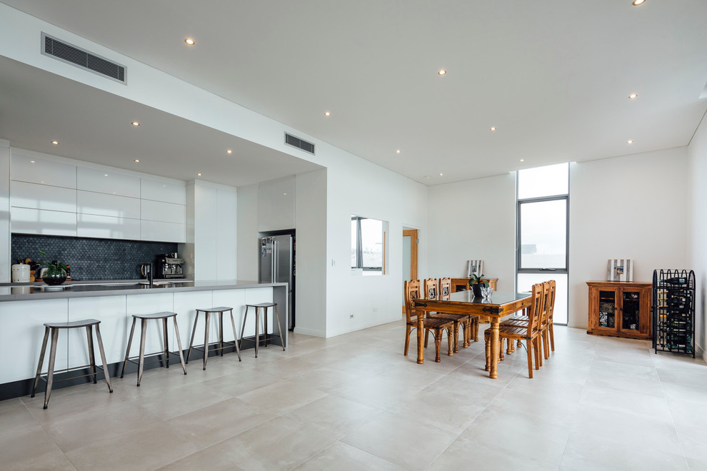 Photo of a mid-sized scandinavian open plan dining in Newcastle - Maitland with white walls and concrete floors.