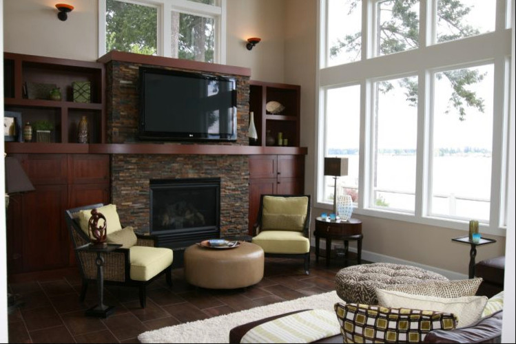 Design ideas for a beach style open concept family room in Seattle with beige walls, a standard fireplace, a stone fireplace surround and a built-in media wall.