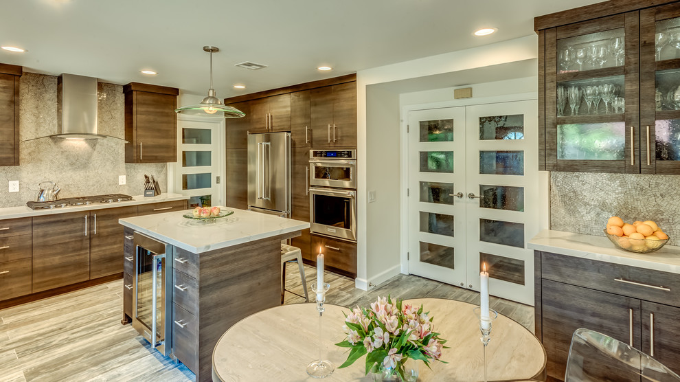 Photo of a mid-sized contemporary u-shaped eat-in kitchen in Los Angeles with an undermount sink, flat-panel cabinets, brown cabinets, quartz benchtops, grey splashback, marble splashback, stainless steel appliances, ceramic floors, with island and multi-coloured floor.