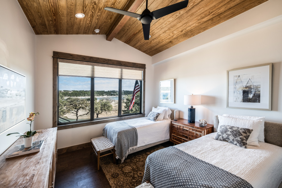 Inspiration for a transitional guest bedroom in Austin with white walls, dark hardwood floors, no fireplace, brown floor, exposed beam, vaulted and wood.