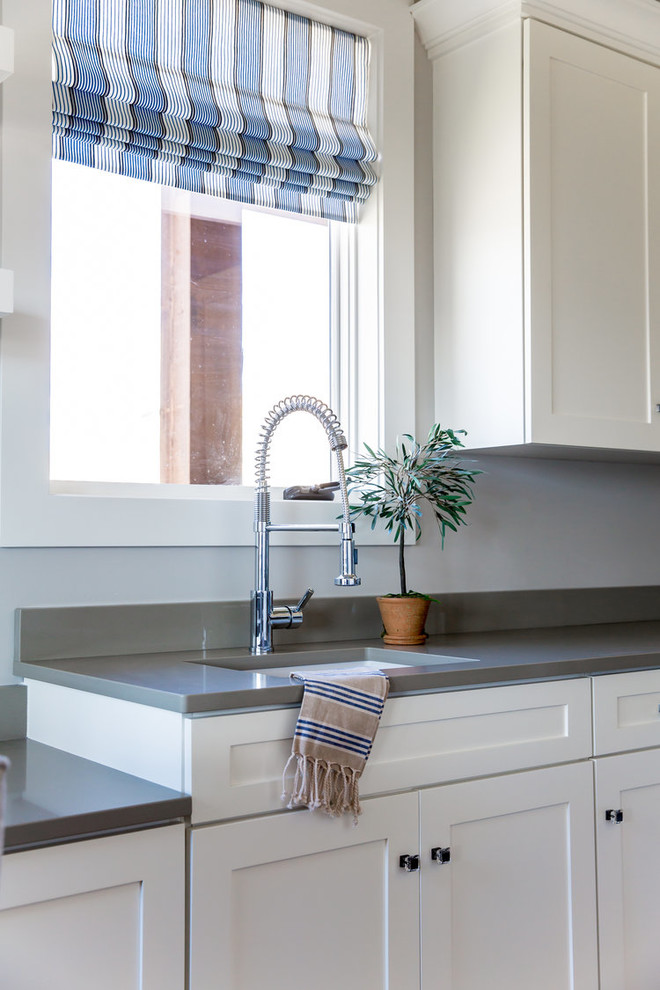 Laundry room - mid-sized transitional laundry room idea in Phoenix with an undermount sink, shaker cabinets, white cabinets, gray walls and gray countertops