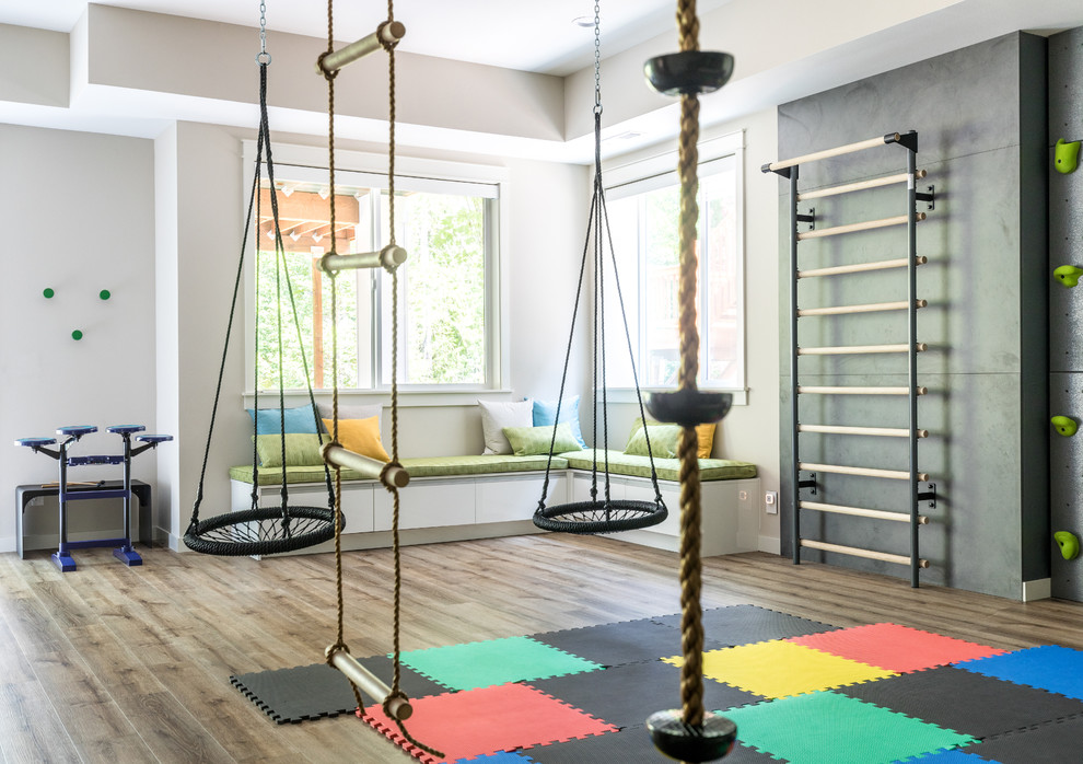 Family Headquarters Play Room - Having two young boys presents its own challenges, and when you have two of their best friends constantly visiting, you end up with four super active action heroes. This family wanted to dedicate a space for the boys to hangout. We took an ordinary basement and converted it into a playground heaven.  A basketball hoop, climbing ropes, swinging chairs, rock climbing wall, and climbing bars, provide ample opportunity for the boys to let their energy out, and the built-in window seat is the perfect spot to catch a break. Tall built-in wardrobes and drawers beneath the window seat to provide plenty of storage for all the toys. 

You can guess where all the neighborhood kids come to hangout now ☺