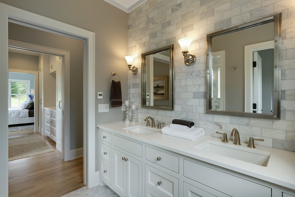 Photo of a mid-sized country master bathroom in Minneapolis with white cabinets, an alcove shower, a two-piece toilet, multi-coloured tile, marble floors, beaded inset cabinets, stone tile, grey walls, an undermount sink, engineered quartz benchtops and white benchtops.