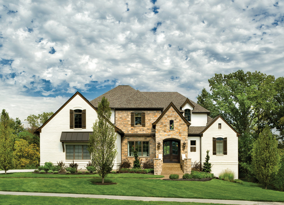Inspiration for a large transitional two-storey white exterior in Cincinnati with mixed siding and a hip roof.