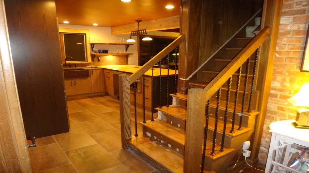 Inspiration for a mid-sized rustic kitchen remodel with medium tone wood cabinets, wood countertops, metallic backsplash and an island