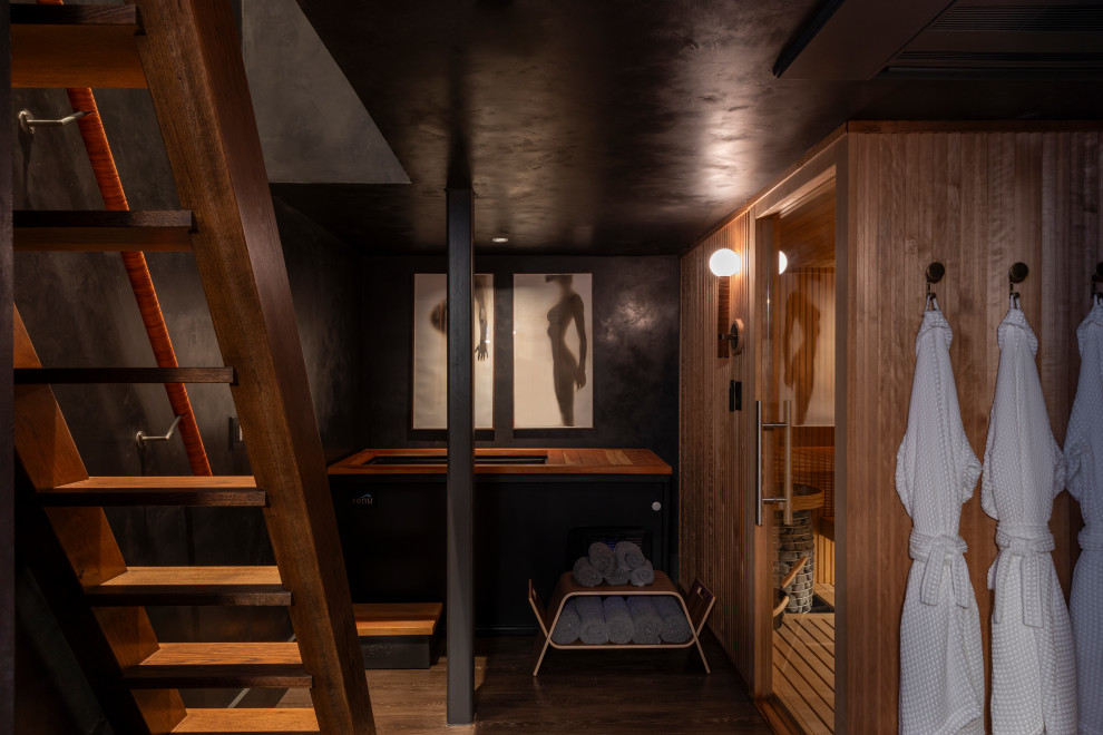 Example of a transitional basement design in Austin with black walls
