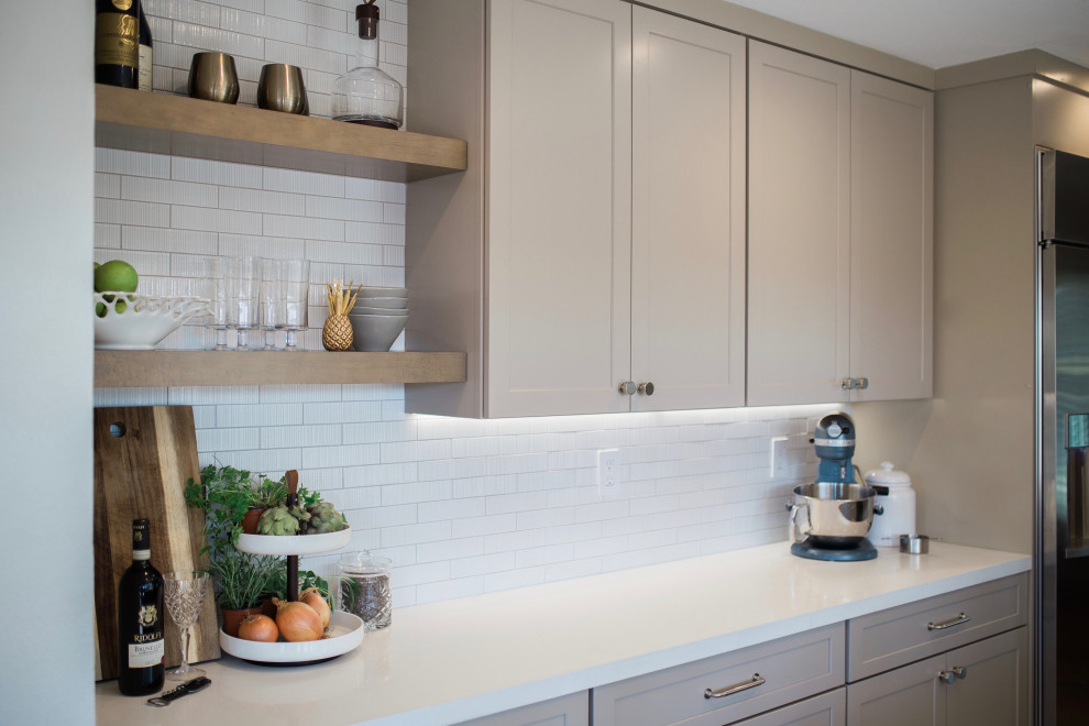 Small transitional galley porcelain tile and beige floor open concept kitchen photo in Orange County with a double-bowl sink, shaker cabinets, beige cabinets, quartz countertops, white backsplash, subway tile backsplash, stainless steel appliances, no island and white countertops