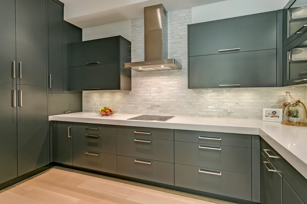 Inspiration for a large transitional l-shaped light wood floor open concept kitchen remodel in Toronto with an undermount sink, flat-panel cabinets, gray cabinets, quartzite countertops, white backsplash, porcelain backsplash, stainless steel appliances, an island and white countertops