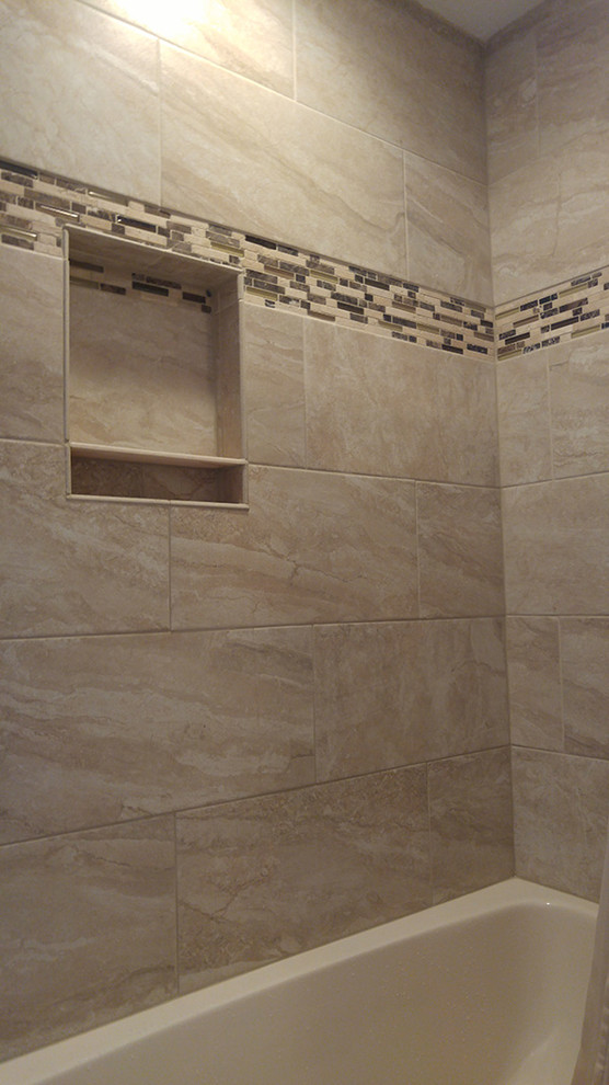 Alcove bathtub - mid-sized transitional 3/4 beige tile and ceramic tile ceramic tile alcove bathtub idea with shaker cabinets, dark wood cabinets, a two-piece toilet, white walls, an integrated sink and quartz countertops