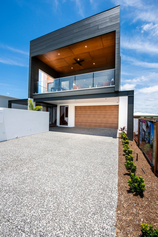 Inspiration for a contemporary two-storey black house exterior in Sunshine Coast with a flat roof and a metal roof.