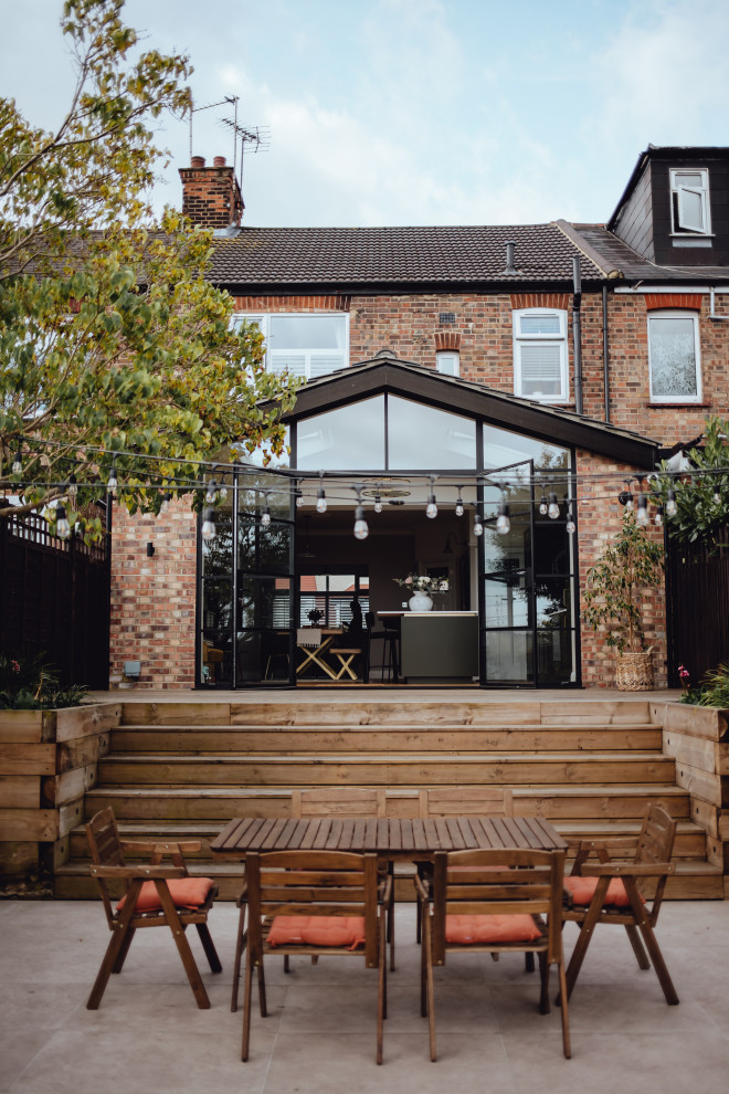 This is an example of a classic patio in London with no cover.