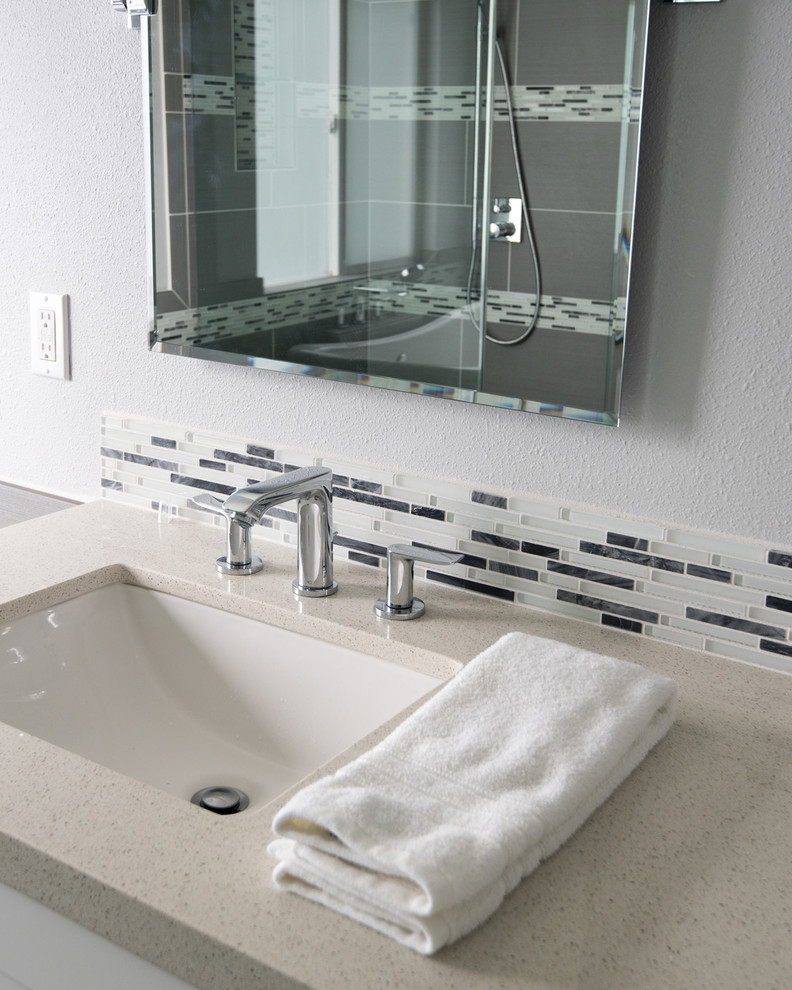 Design ideas for a large modern master bathroom in San Diego with an undermount sink, shaker cabinets, white cabinets, glass benchtops, a freestanding tub, a corner shower, a one-piece toilet, gray tile, porcelain tile, white walls and porcelain floors.